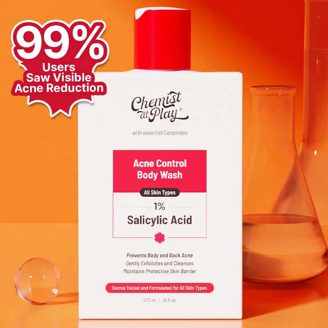 A bottle of "Chemist At Play Acne Control Body Wash" with a red cap, positioned against an orange background. The text highlights that 99% of users saw visible acne reduction. The product is shown alongside laboratory glassware to emphasize its scientific formulation.