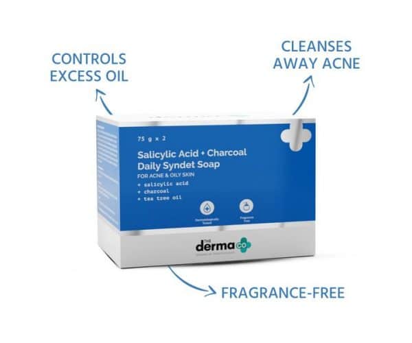 The Derma Co Salicylic Acid + Charcoal Daily Syndet Soap packaging with text highlighting benefits: controls excess oil, cleanses away acne, and fragrance-free.