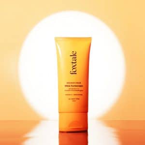 Single tube of Foxtale Golden Hour Glow Sunscreen SPF 50 standing upright with a glowing background, showcasing its benefits for all skin types.