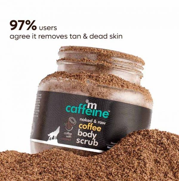 A jar of mcaffeine Exfoliating Coffee Body Scrub with coffee grounds spilling out, highlighting the product’s tan removal and dead skin exfoliation benefits.